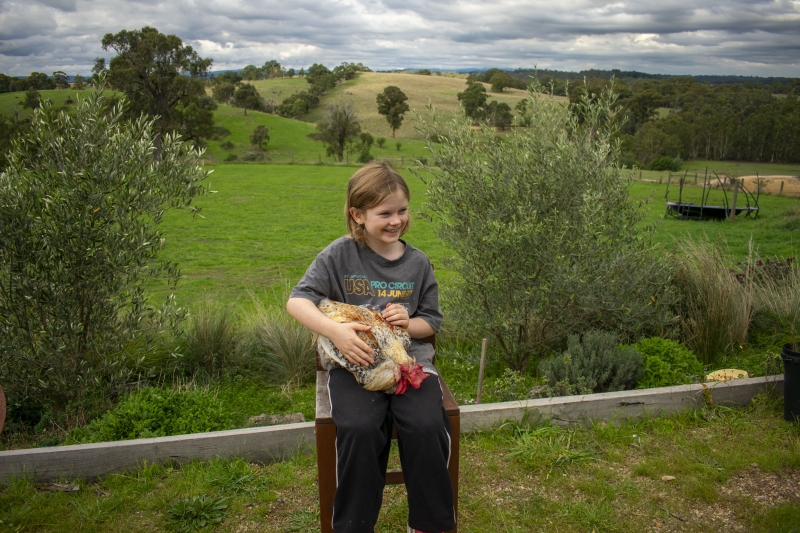 10-year-old Hugo holds a rooster