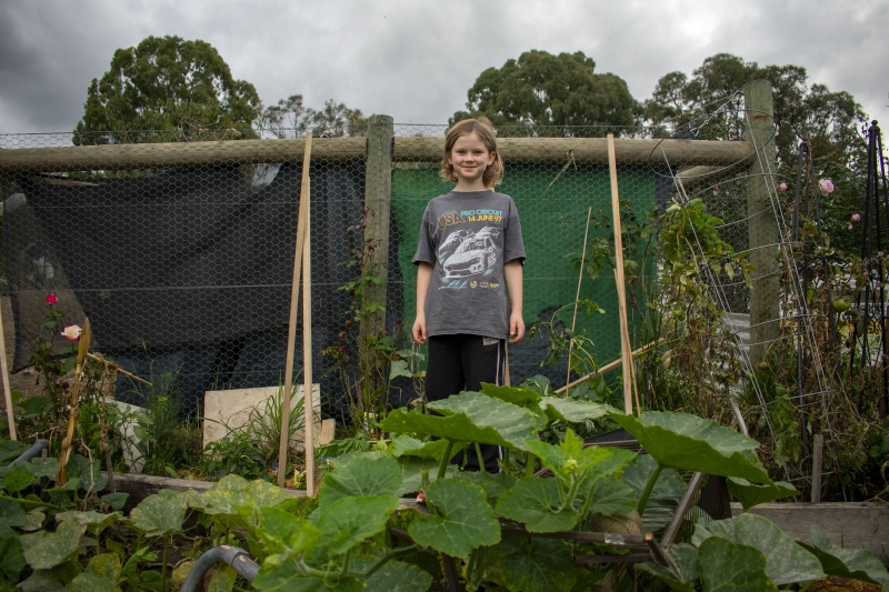10-year-old Hugo stands in his vegie patch