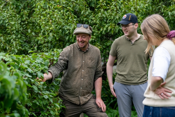 Julian leads a couple on a garden tour